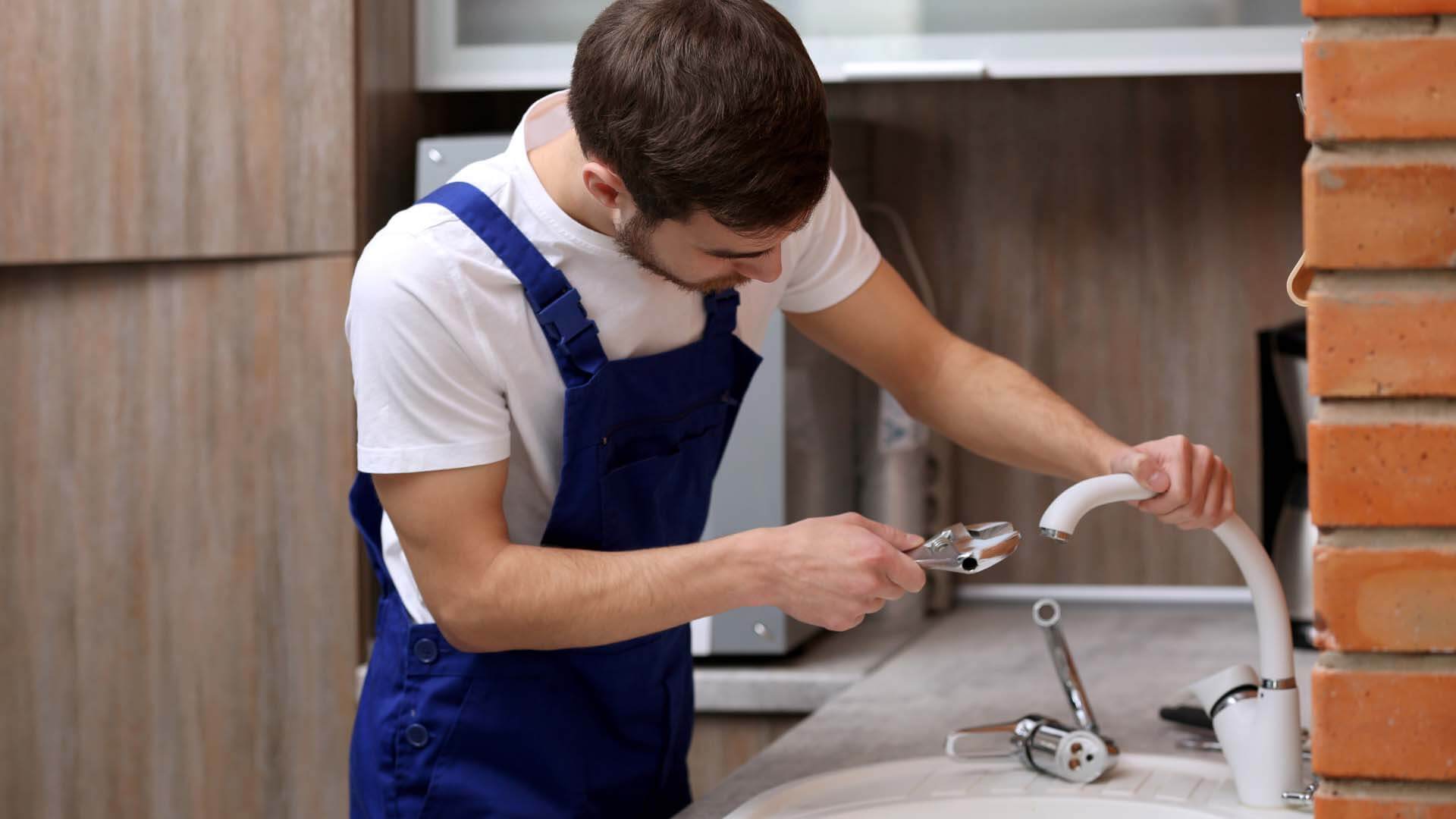 Plumber Performing a Faucet Replacement