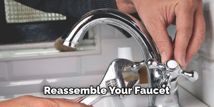 Homeowner reassembling and testing a kitchen faucet after completing a leaky faucet repair