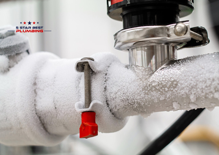 Heavily frosted and frozen metal water pipes showing signs of ice buildup and potential bursting risk.